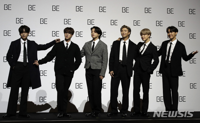 Members of South Korean K-pop band BTS pose for photographers during a press conference to introduce their new album &quot;BE&quot; in Seoul, South Korea, Friday, Nov. 20, 2020. K-pop band BTS has released their highly anticipated new album, which they describe as a “letter of hope.” The band held a socially distanced news conference in Seoul to unveil “BE,” its second album this year. (AP Photo/Lee Jin-man)