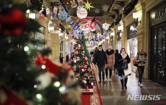 [모스크바=AP/뉴시스]23일(현지시간) 러시아 모스크바의 굼(GUM) 백화점이 크리스마스와 새해 축하 장식으로 꾸며진 가운데 마스크를 쓴 시민들이 백화점 내부를 걷고 있다. 2020.11.24.