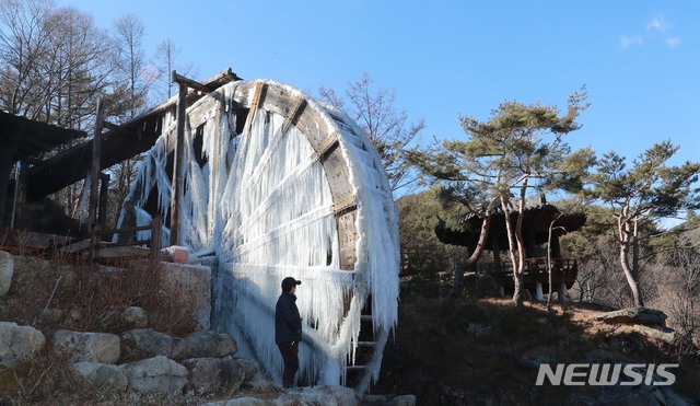 [함양=뉴시스]17일 경남 함양군 안의면 상원리 연암물레방아공원에 설치된 물레방아가 강추위에 꽁꽁 얼어 멈춰 서 있다. (사진=함양군 제공) 2020.12.17. photo@newsis.com