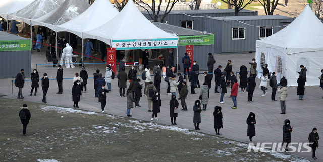 [서울=뉴시스]김선웅 기자 = 1062명의 신규 코로나19 확진자가 발생한 18일 서울광장에 설치된 중구 임시 선별검사소에서 시민들이 코로나19 검사를 받기 위해 줄을 서고 있다. 2020.12.18. mangusta@newsis.com