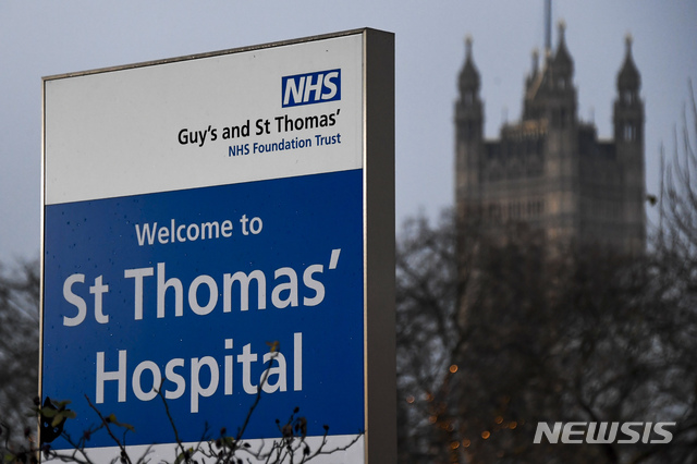 FILE - In this Tuesday, Dec. 8, 2020 file photo, a welcome sign at the entrance of St Thomas&#039; Hospital, one of several hospitals around Britain that are handling the initial phase of a COVID-19 immunization program, in London. British hospitals are cancelling non-urgent procedures and scrambling to find space for COVID-19 patients as coronavirus cases continue to surge despite tough new restrictions imposed to curb a fast-spreading new variant of the virus. Dr. Nick Scriven of the Society for Acute Medicine said Monday, Dec. 28, 2020 that “with he numbers approaching the peaks from April, systems will again be stretched to the limit.” (AP Photo/Alberto Pezzali, File)