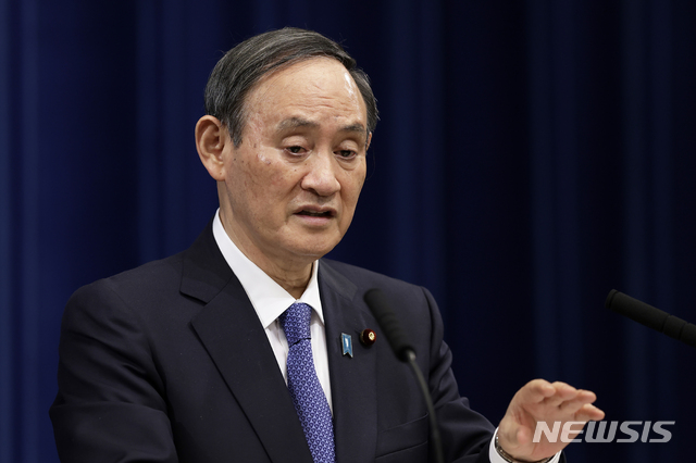 Japan&#039;s Prime Minister Yoshihide Suga speaks during a news conference at the prime minister&#039;s official residence in Tokyo, Thursday, Jan. 7, 2021. Japan has declared a state of emergency for Tokyo and three nearby areas as coronavirus cases continued to surge, hitting a daily record of 2,447 in the capital. (Kiyoshi Ota/Pool Photo via AP)