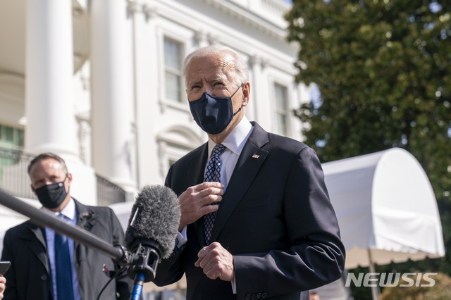 President Joe Biden speaks to reporters before boarding Marine One on the South Lawn of the White House in Washington, Friday, March 19, 2021, for a short trip to Andrews Air Force Base, Md., and then on to Atlanta. (AP Photo/Andrew Harnik)