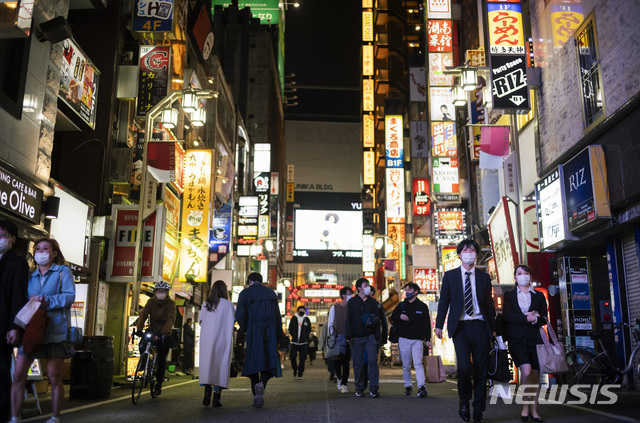 [도쿄=AP/뉴시스] 일본 도쿄 환락가 신주쿠에서 9일 밤 술집과 식당을 찾아가는 시민들이 코로나19 예방을 위해 마스크를 착용한 채 바쁘게 움직이고 있다. 2021.04.10  