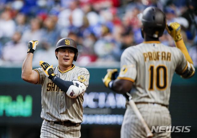 San Diego Padres&#039; Ha-Seong Kim, right, is congratulated by Jurickson Profar (10) after hitting a solo home run during the fifth inning of a baseball game against the Texas Rangers, Saturday, April 10, 2021, in Arlington, Texas. (AP Photo/Brandon Wade)