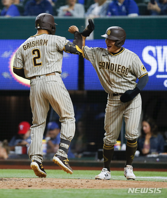 San Diego Padres&#039; Trent Grisham (2) is congratulated by Ha-Seong Kim after hitting a two-run home run during the seventh inning of a baseball game against the Texas Rangers, Saturday, April 10, 2021, in Arlington, Texas. (AP Photo/Brandon Wade)