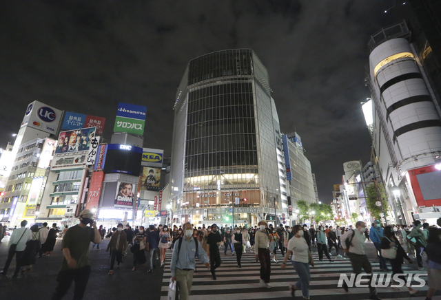 [도쿄=AP/뉴시스] 일본 수도 도쿄 번화가 시부야에서 지난달 31일 저녁 코로나19 예방을 위해 마스크를 착용한 시민들이 횡단보도를 건너고 있다. 2021.06.25/
