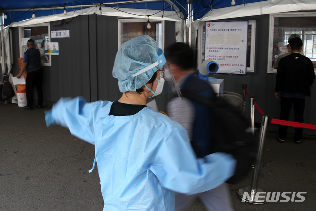 [서울=뉴시스]조성우 기자 = 코로나19 신규 확진자 수가 나흘 만에 600명대로 올라선 9일 오전 서울 중구 서울역 임시선별검사소에서 의료진이 시민들을 안내하고 있다. 2021.06.09. xconfind@newsis.com