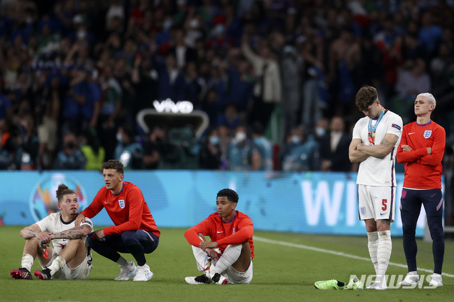 England players react after Italy won the Euro 2020 soccer championship final match between England and Italy at Wembley stadium in London, Sunday, July 11, 2021. Italy defeated England 3-2 in a penalty shootout after the game ended in a 1-1 draw. (Carl Recine/Pool Photo via AP)