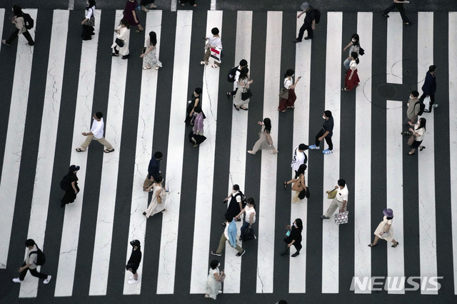 [도쿄=AP/뉴시스] 22일 일본 도쿄에서 코로나19 확산을 막기 위해 마스크를 쓴 시민들이 건널목을 건너고 있다. 2021.07.22