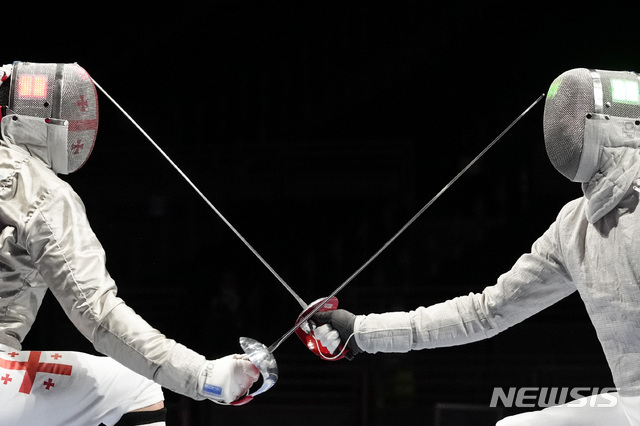 [도쿄=AP/뉴시스] 오상욱(오른쪽)이 24일 2020 도쿄올림픽 펜싱 남자 사브르 8강전에서 산드로 바자제(조지아)를 상대하고 있다. 