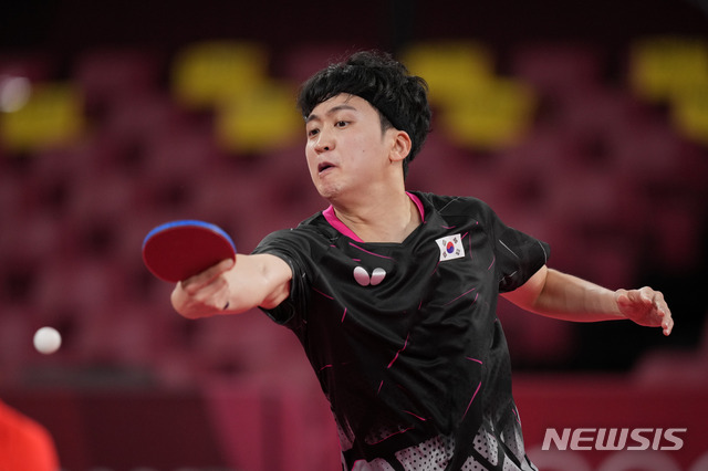 South Korea's Jeoung Young-sik competes during the table tennis men's singles round of 16 match against Germany's Timo Boll at the 2020 Summer Olympics, Tuesday, July 27, 2021, in Tokyo. (AP Photo/Kin Cheung)