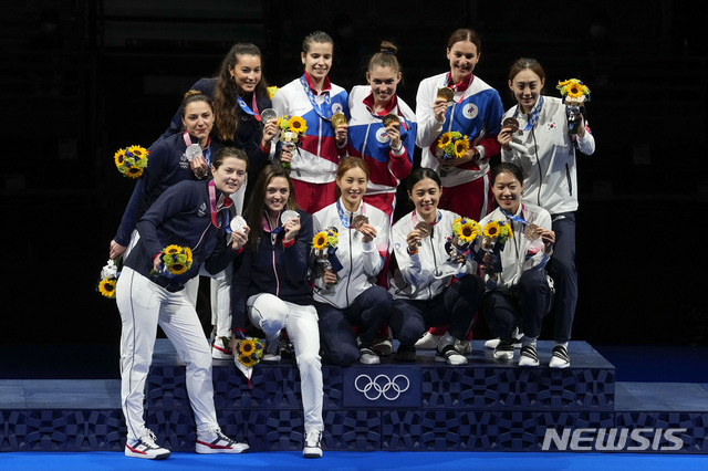 Silver medalists of France, left, gold medalists Russian Olympic Committee, top, and bronze medalists of South Korea pose for photos one the podium of the women&#039;s Sabre team at the 2020 Summer Olympics, Saturday, July 31, 2021, in Chiba, Japan. (AP Photo/Andrew Medichini)