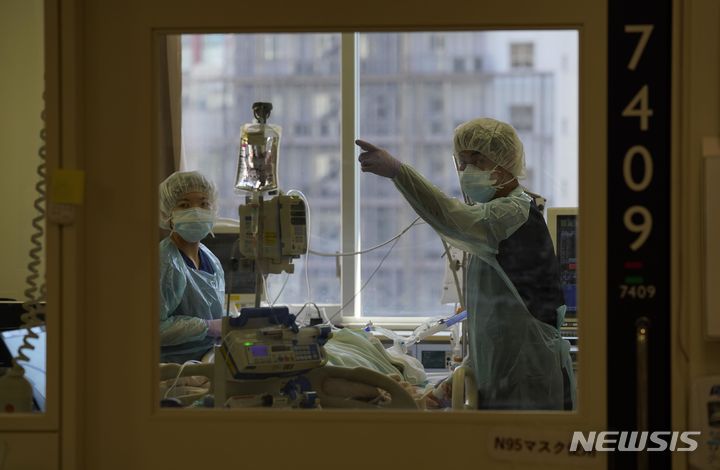 [도쿄=교도A/뉴시스]간호사들이 일본 도쿄의 한 대학병원에 있는 밀폐된 병실에서 코로나19에 감염된 중환자를 돌보고 있는 모습. 202211.15.