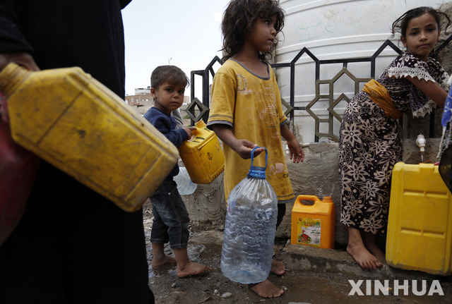 [사나=신화/뉴시스] 17일(현지시간) 예멘 수도 사나에서 어린이들이 자선단체가 제공하는 깨끗한 물을 받기 위해 빈 병을 들고 줄 서 있다. 2021.08.18.