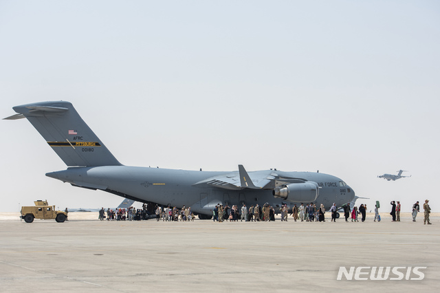 [AP/뉴시스] 23일 카타르의 알우데이다 미 공군기지에 미군 수송기가 착륙해 아프간 철수 민간인들을 내려보내고 있다. 