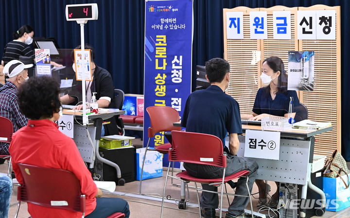 [수원=뉴시스] 김종택기자 = 코로나 상생 국민지원금 오프라인 신청 첫날인 13일 오전 경기도 수원시 행궁동 행정복지센터에서 시민들이 지원금을 신청하고 있다. 2021.09.13. jtk@newsis.com