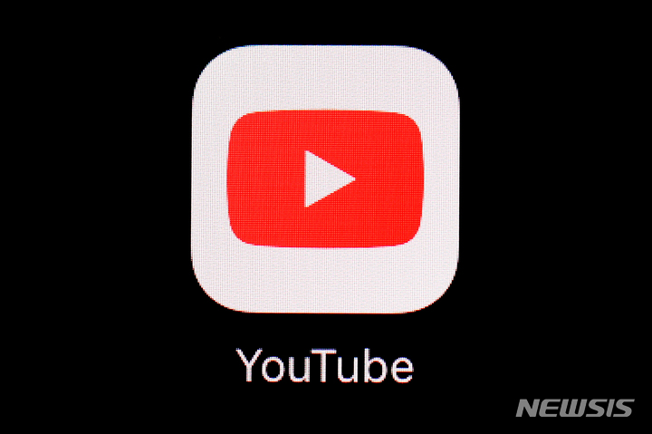 FILE - This March 20, 2018, file photo shows the YouTube app on an iPad in Baltimore. Video-sharing tech platform YouTube on Wednesday, Sept. 29, 2021, announced immediate bans on false claims that vaccines are dangerous and cause health issues like autism, cancer or infertility.  (AP Photo/Patrick Semansky, File)