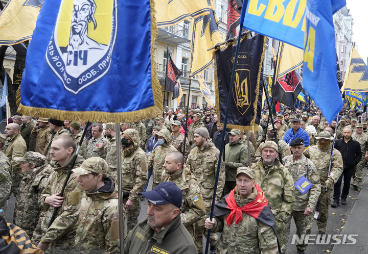 [키예프(우크라이나)=AP/뉴시스]우크라이나 수호의 날인 지난달 14일 우크라이나 참전 용사들이 수도 키예프의 기념 집회에 참가, 시내를 행진하고 있다. 2021.11.27.