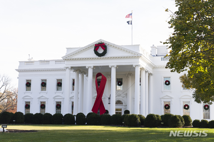 [워싱턴= AP/뉴시스] 지난 해 12월1일 에이즈의 날을 맞아 백악관 북관에 장식된 붉은 리본 장식.  미 버지니아주 연방지법원은 미군내 HIV 바이러스 (에이즈) 양성반응자에 대한 차별과 배치금지 등을 막는 새로운 법원 명령을 내려 HIV양성자를 보호하는 획기적인 판결로 주목받고 있다.