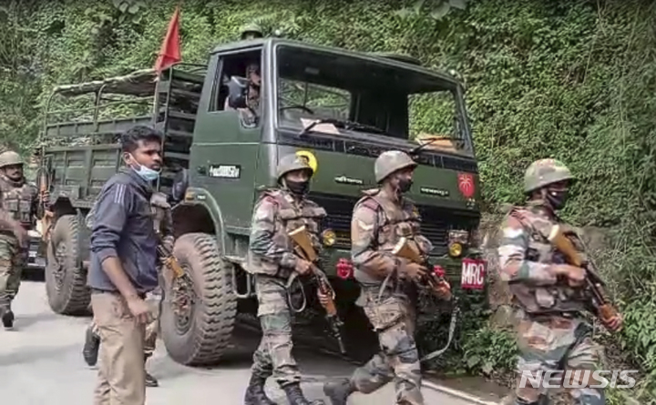 This image from video shows Indian army soldiers arriving at the site after an army helicopter carrying India's Chief of Defense Staff Bipin Rawat crashed near Coonoor, Tamil Nadu state, India, Wednesday, Dec. 8, 2021. (KK Productions via AP)
