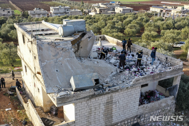 [AP/뉴시스] 미군 특전사 요원들이 한밤에 급습 공격한 시리아 북서부 이들립주 아트메 한 건물을 한나절 지난 3일 낮 사람들이 조사하고 있다 
