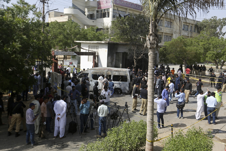 [카라치=AP/뉴시스] 26일(현지시간) 파키스탄 남부 도시 카라치에 있는 카라치 대학교에서 발생한 폭탄 테러로 밴에 타고 있던 3명의 중국인과 파키스탄인 운전자가 사망했다. 폭발 현장에 경찰과 언론인들이 모인 모습.  *재판매 및 DB 금지