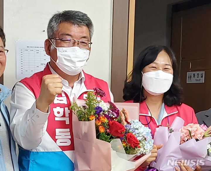 [안동=뉴시스] 김진호 기자 = 김학동 국민의힘 경북 예천군수 후보가 13일 6.1지방선거에서 무투표 당선이 확정된 뒤 지지자들로부터 꽃다발을 받고 있다. 2022.05.13 kjh9326@newsis.com