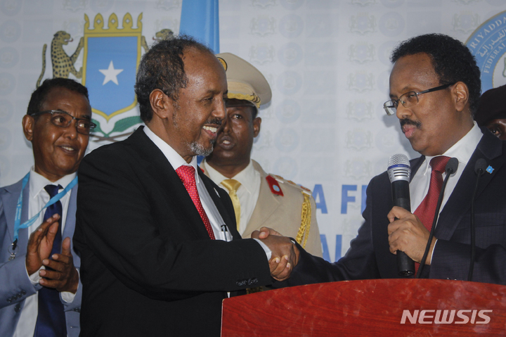 [ 모가디슈 (소말리아)= AP/뉴시스]소말리아의 하산 셰이크 모하무드 대통령과 전임 모하메드 대통령이 15일 의회에서 3차 결선투표가 끝난뒤 서로 악수르 나누고 있다.  2017년에 단임으로 재선에 패배했다가 다시 대통령직에 돌아온 모하무드 대통령은 그 동안 정치적 혼란과 대결로 얼룩진 소말리아의 단합을 위해 일하겠다고 밝혔다.