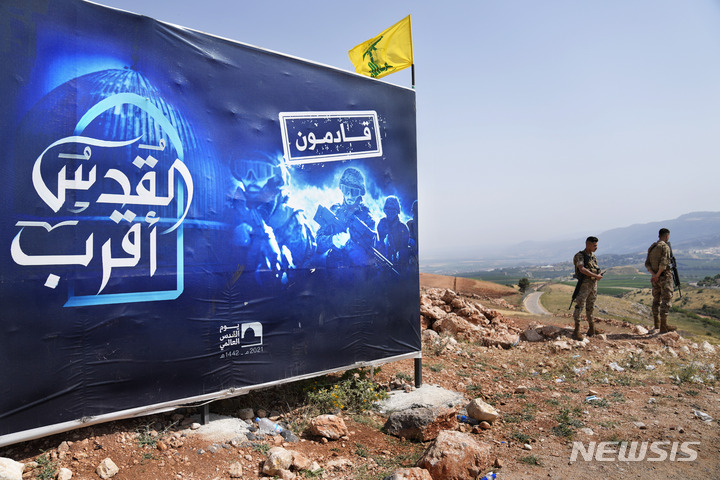 이스라엘과의 국경을 지키는 레바논군인들.  간판에는 "예루살렘이 가까워졌다.  우리가 간다"는 글이 보인다. 