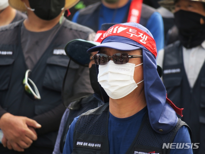 [인천=뉴시스] 김동영 기자 = 민주노총 공공운수노조 화물연대본부가 안전 운임 일몰제 폐지를 요구하며 총파업에 돌입한 7일 오전 인천 연수구 인천 신항 컨테이너 터미널 앞에서 열린 총파업 출정식에서 인천지역본부 조합원들이 구호를 외치고 있다. 2022.06.07. dy0121@newsis.com 