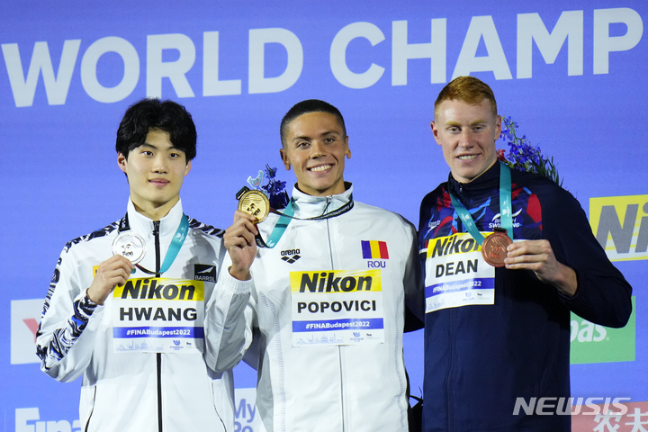 [부다페스트=AP/뉴시스]2022 국제수영연맹(FINA) 부다페스트 세계수영선수권대회 자유형 200m 은메달을 딴 황선우(왼쪽)가 함께 입상한 다비드 포포비치(가운데), 톰 틴과 포즈를 취하고 있다. 2022.06.21.