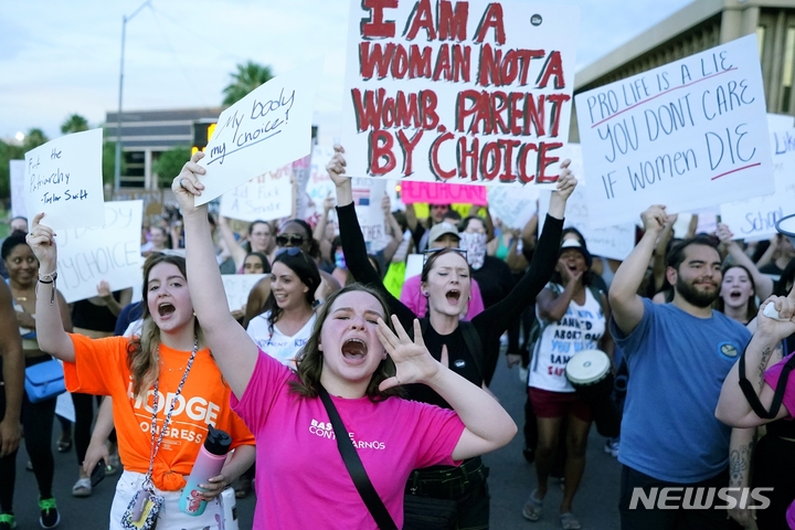 [피닉스( 미 애리조나주)= AP/뉴시스]미 애리조나주 피닉스 시내 주 의회 앞에서 24일(현지시간) 낙태금지법 반대시위 참가자 수 천명이 모여서 여성의 자기 결정권 존중을 요구하며 구호를 외치고 있다.   