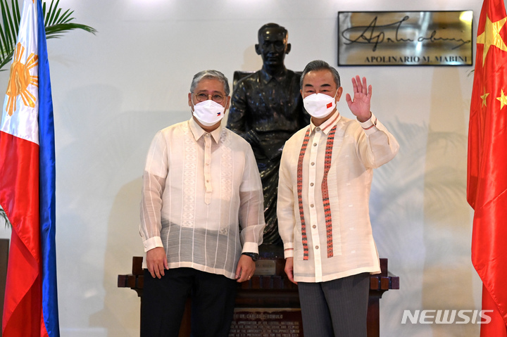 [마닐라=AP/뉴시스]엔리케 마날로 필리핀 외무장관(왼쪽)과 왕이 중국 외교부장이 6일(현지시간) 필리핀 마닐라 외교부에서 열린 양자회담에 앞서 기념촬영을 하고 있다.2022.07.07