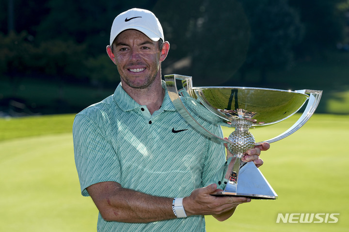 Rory McIlroy, of Northern Ireland, holds the championchip trophy after winning the final round of the Tour Championship golf tournament at East Lake Golf Club, Sunday, Aug. 28, 2022, in Atlanta. (AP Photo/Steve Helber)