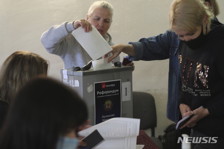 [볼고그라드(러시아)=AP/뉴시스]러시아가 장악 중인 우크라이나 4개 지역(도네츠크·루한스크·자포리자·헤르손주)에서 러시아 영토 편입 찬반을 묻는 주민투표가 23일(현지시간) 시작됐다. 러시아 볼고그라드에 마련된 영외 투표소에서 루한스크 주민이 투표하고 있다. 2022.09.23