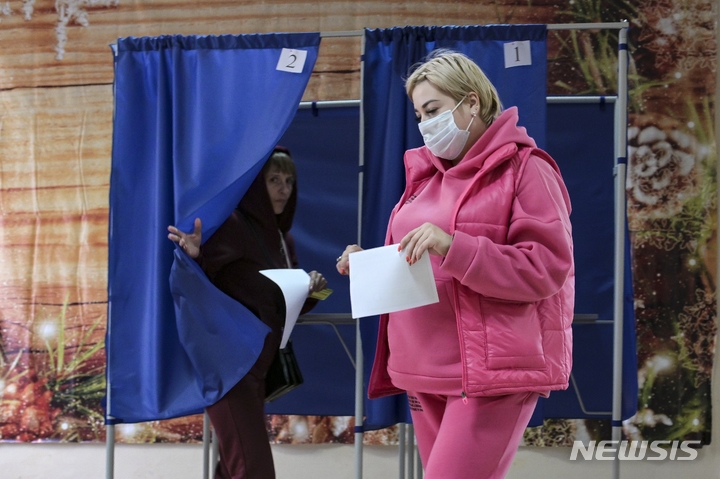 [도네츠크=AP/뉴시스] 27일(현지시간) 우크라이나 동부 도네츠크 투표소에서 유권자들이 국민투표를 마친 뒤 부스에서 나오고 있다. 2022.09.28.