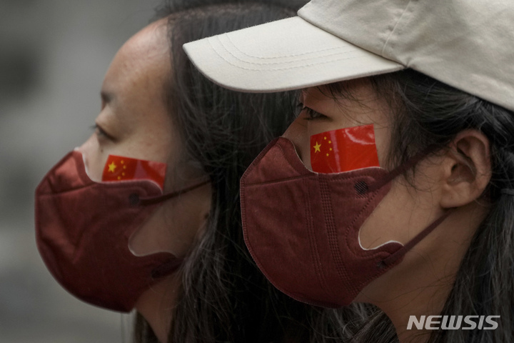 [베이징=AP/뉴시스] 여성이 2일 일주일 간의 국경절 연휴기간에 오성홍기를 얼굴에 그린 채 베이징 거리를 걷고 있다. 2022.10.04.