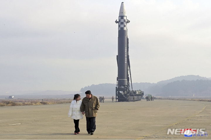 [평양=AP/뉴시스] 북한 조선중앙통신에 공개한 사진에 18일 김정은 북한 국무위원장이 딸의 손을 잡고 화성-17형 대륙간탄도미사일(ICBM) 시험 발사장을 현지 지도하고 있다. 2022.11.19.