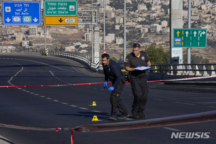 [예루살렘=AP/뉴시스] 23일(현지시간) 이스라엘 경찰이 예루살렘 버스 정거장 폭발 사건 현장을 조사하고 있다. 이날 예루살렘 버스 정거장 2곳에서 폭발로 1명이 사망하고 18명이 부상했다. 2022.11.23