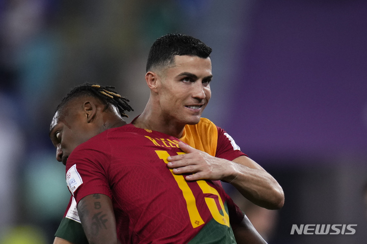 Portugal's Cristiano Ronaldo embraces teammate Rafael Leao after their 3-2 won over Ghana during a World Cup group H soccer match at the Stadium 974 in Doha, Qatar, Thursday, Nov. 24, 2022. (AP Photo/Manu Fernandez)