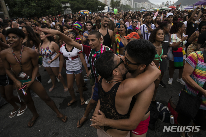 [리우데자네이루=AP/뉴시스] 27일(현지시간) 브라질 리우데자네이루 코파카바나 해변에서 제27회 게이 프라이드 퍼레이드(Gay Pride Parade)가 열린 가운데 한 커플이 키스를 하고 있다. 2022.11.28.
