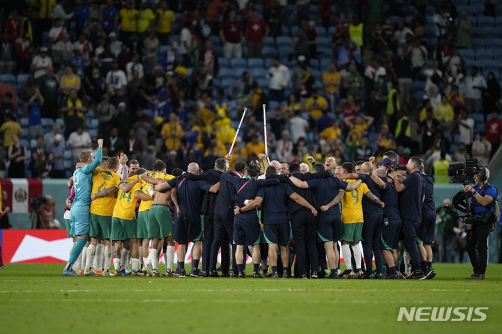 Australia's soccer team players celebrate their victory during the World Cup group D soccer match between Australia and Denmark, at the Al Janoub Stadium in Al Wakrah, Qatar, Wednesday, Nov. 30, 2022. (AP Photo/Darko Vojinovic)