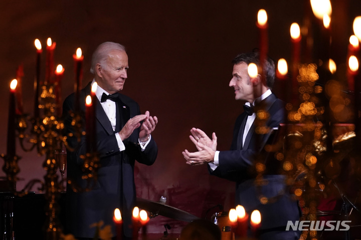 [워싱턴=AP/뉴시스] 조 바이든(왼쪽) 미국 대통령과 에마뉘엘 마크롱 프랑스 대통령이 1일(현지시간) 백악관 사우스론에서 열린 국빈 만찬 중 건배에 앞서 박수하고 있다. 2022.12.02.
