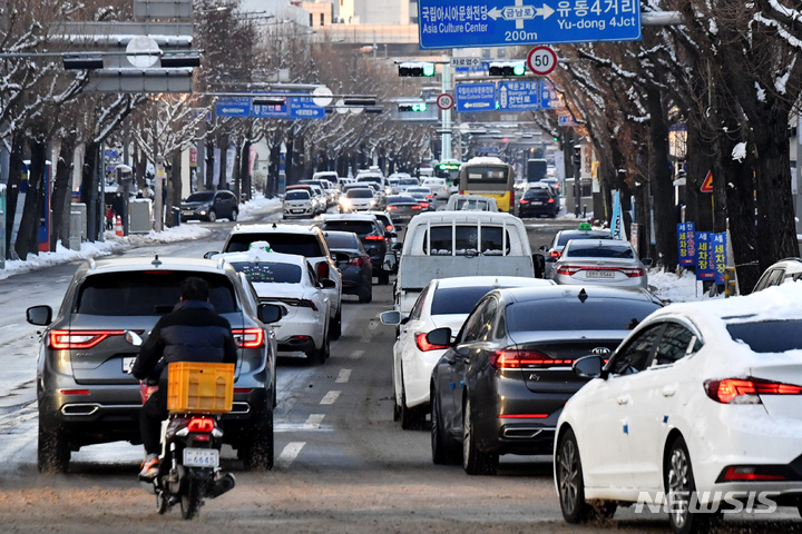 [광주=뉴시스] 이영주 기자 = 19일 오전 광주 동구 대인광장에서 빙판길을 염려한 차량들이 거북이 운행을 하고 있다. 2022.12.19. leeyj2578@newsis.com