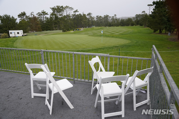 The ninth green of the Spyglass Hill Golf Course is empty after the third round of the AT&T Pebble Beach Pro-Am golf tournament was supended due to inclement weather in Pebble Beach, Calif., Saturday, Feb. 4, 2023. (AP Photo/Eric Risberg)