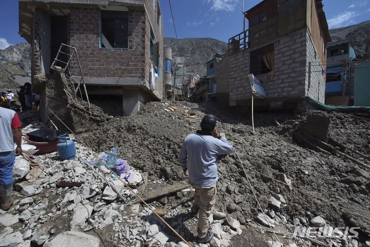 [카마나=AP/뉴시스] 한 주민이 7일(현지시간) 페루 카마나에서 산사태로 붕괴된 집 밖에 서 있다. 페루 당국은 폭우로 시작된 산사태로 진흙과 물, 돌이 남부지역 마을 곳곳을 덮쳤다고 전했다. 2023.02.08.