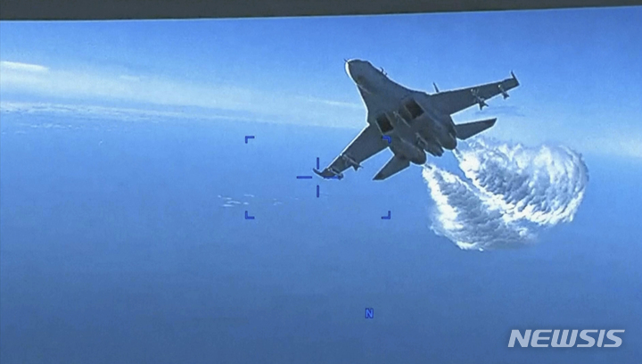 [워싱턴=AP/뉴시스]미 국방부가 16일 공개한 동영상을 촬영한 이 사진은 러시아의 Su-27 전투기가 흑해 상공의 국제 공역에서 미국의 MQ-9 무인기 뒤쪽으로 접근, 연료를 방출하는 모습을 보여주고 있다. 2023.3.16