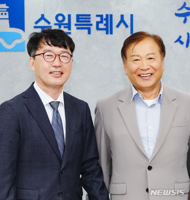 김성진(왼쪽) 수원시정연구원장이 허재완 이사장으로부터 임명장을 받고 기념사진을 찍고 있다.