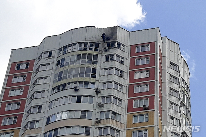 [AP/뉴시스] 30일 새벽 공격 드론이 모스크바 아파트 벽을 때린 것으로 알려진 가운데 조사관이 타격 지점을 살피고 있다. 러시아 국방부는 우크라 소행이라고 주장했다. 2023. 05. 30.